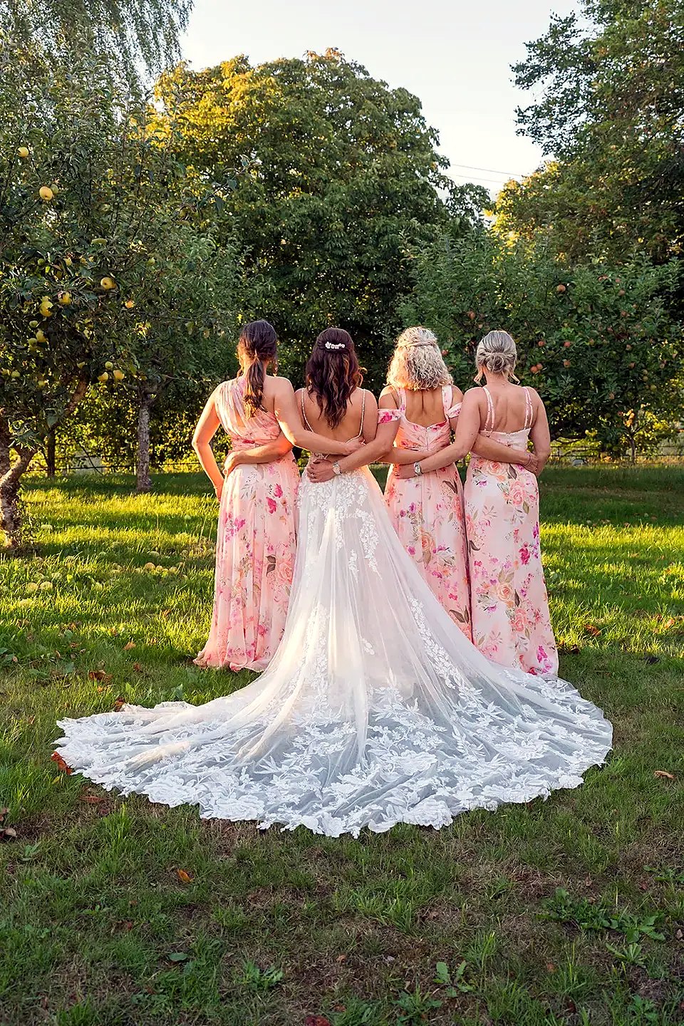 Bride and bridesmaids in an English orchard