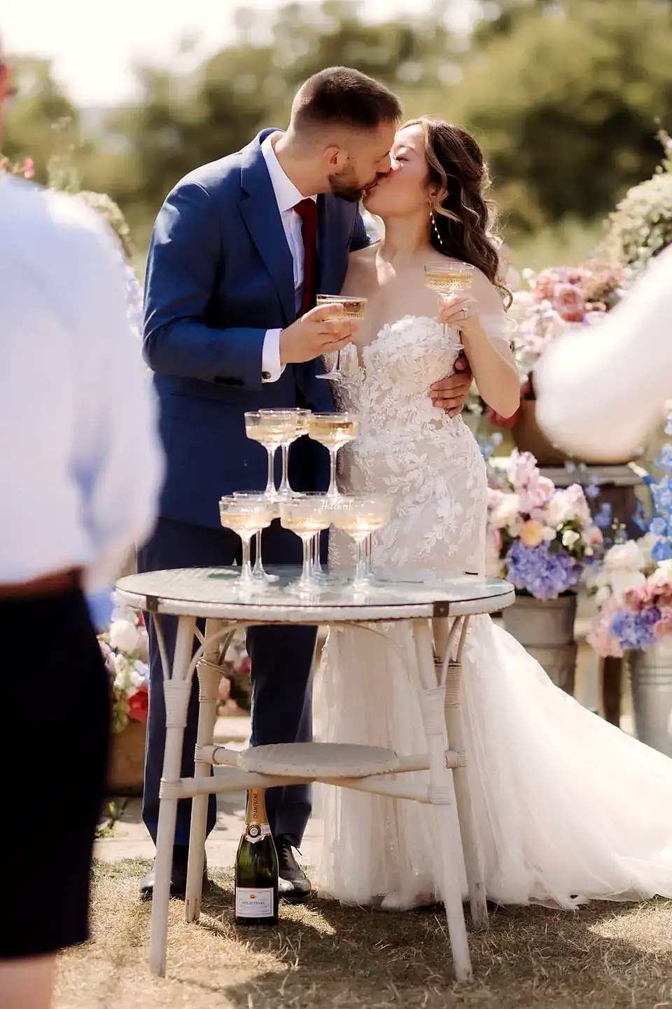 Couple kissing behind a champagne tower